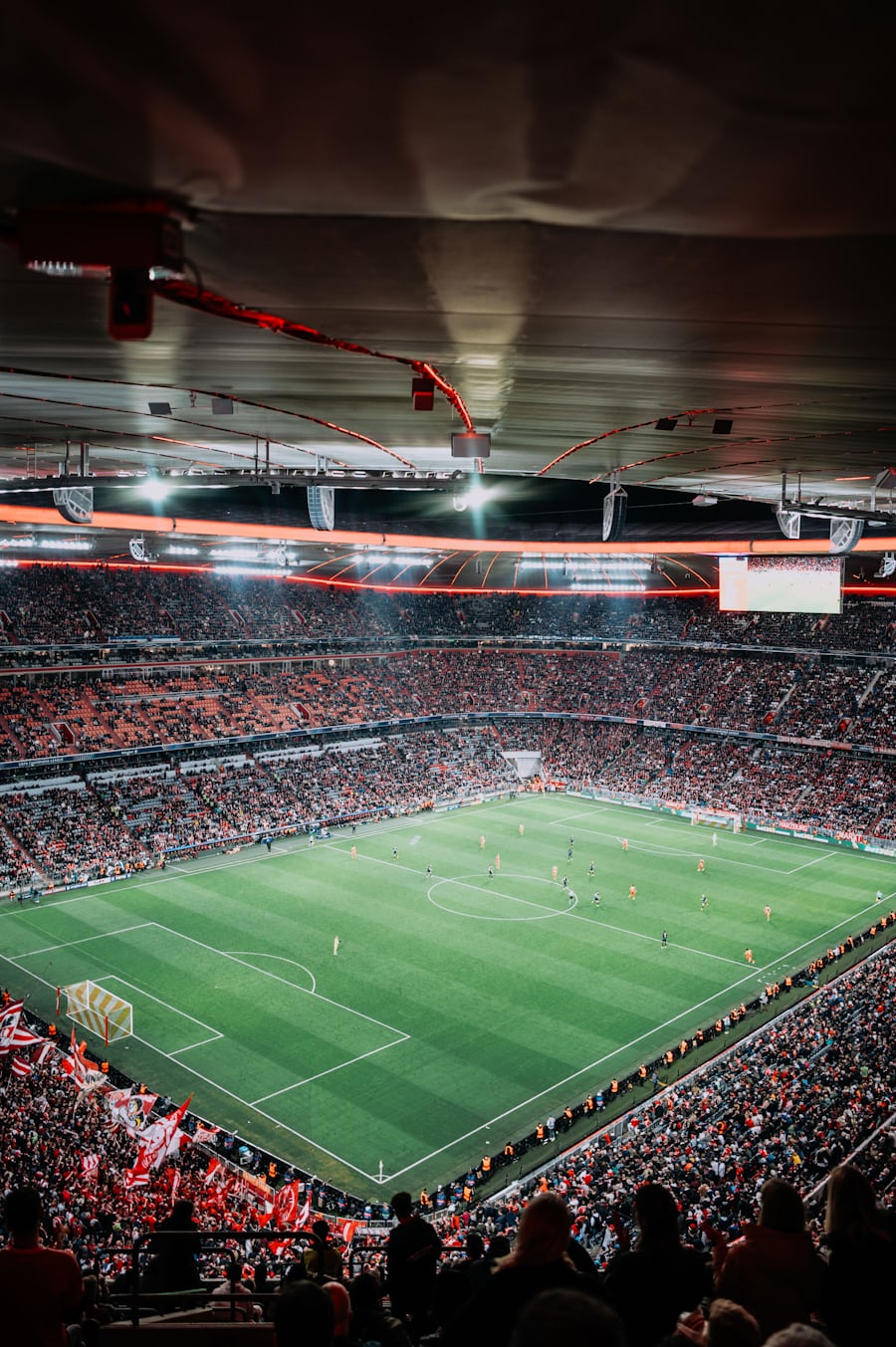 Stadion sepak bola yang penuh penonton di malam hari